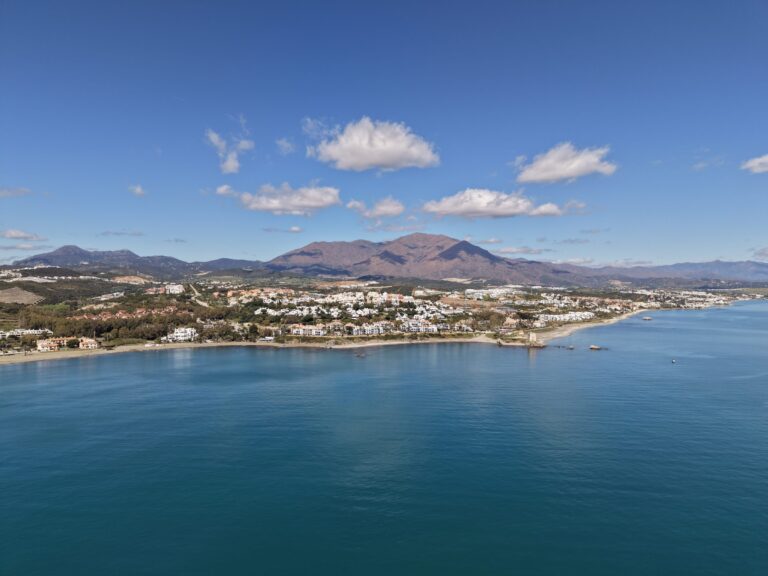 The coast at Casares Costa seen from the sea, with the mountains behind